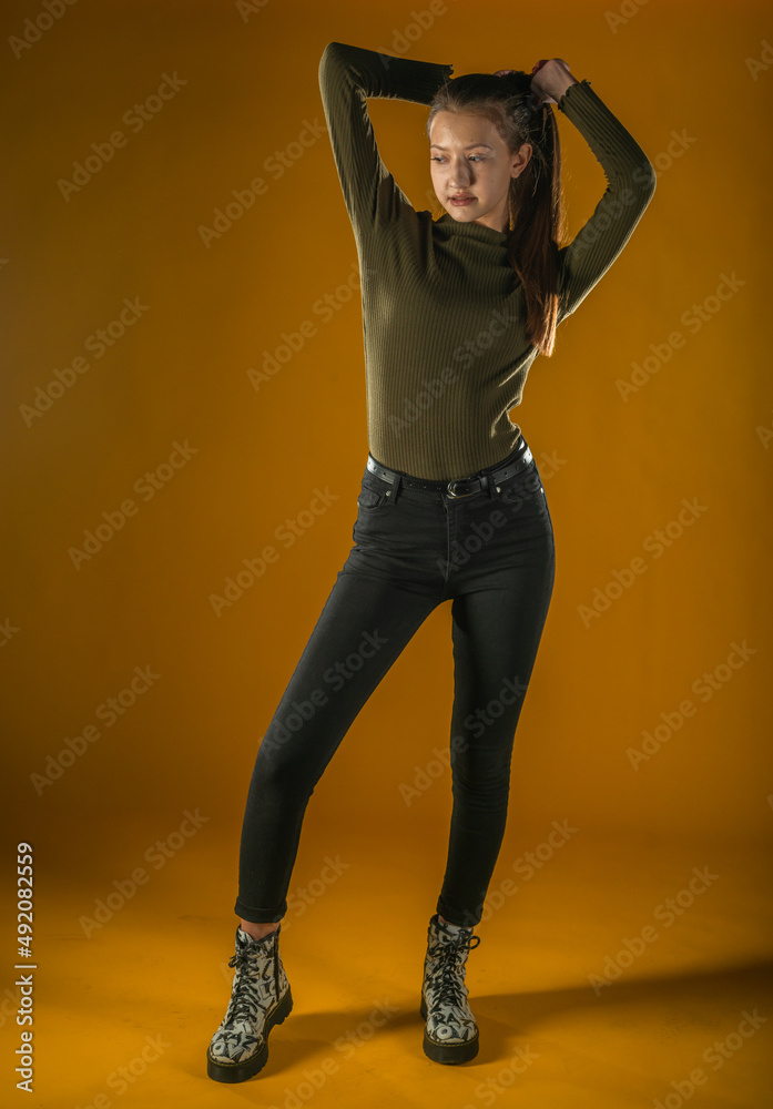 Young Woman with spring hat against yellow background Young Woman with spring hat against yellow background