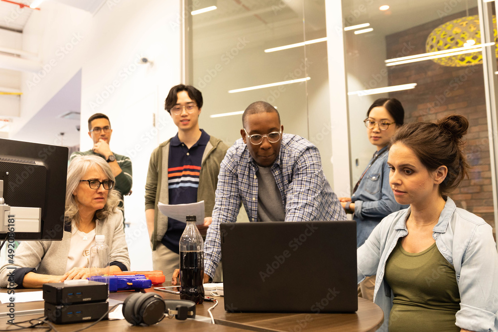Computer programmers working in open plan office Stock Photo | Adobe Stock