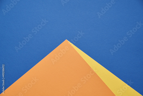 Pyramid on a blue background. Minimalism, abstraction. Flat table