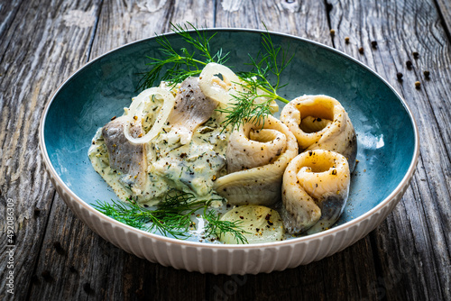 Фотография Swedish style marinated herring fillets in mayonnaise and cream with pickled cuc
