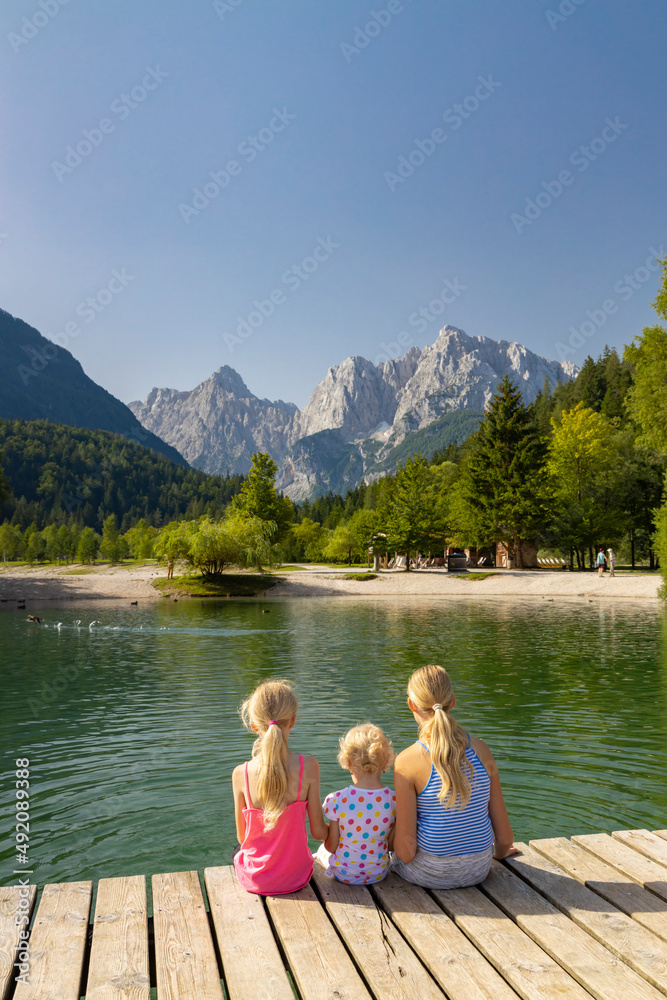 Children by the lake near village Kranjska Gora in Triglav national park, Slovenia