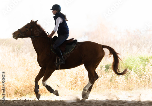 Young girl riding a horse