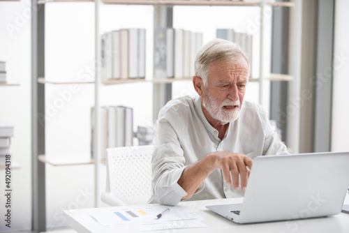 senior businessman using laptop computer and serious at work