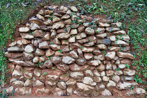 Stones decorate the walls and grass grows naturally. photo