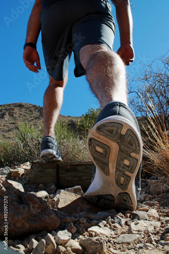 person running on the trail, close up of shoes