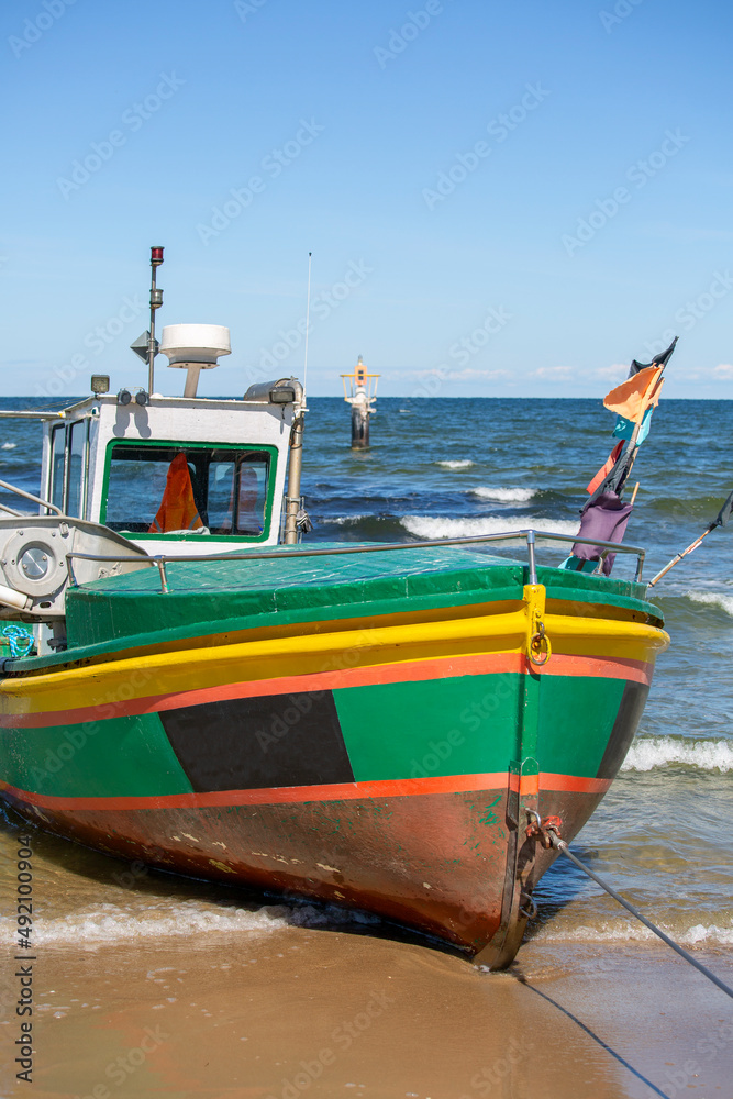 Fishing boat by the sandy beach on the Baltic Sea on a sunny day, Sopot, Poland. Fishing boat by the sandy beach on the Baltic Sea on a sunny day, Sopot, Poland.