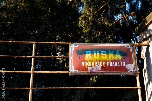 Canvas Print Red street sign Ruska - translation:Russian - is painted over with blue and yellow color as Ukrainian flag in Prague Vrsovice as protest against Russian aggressions in Ukraine