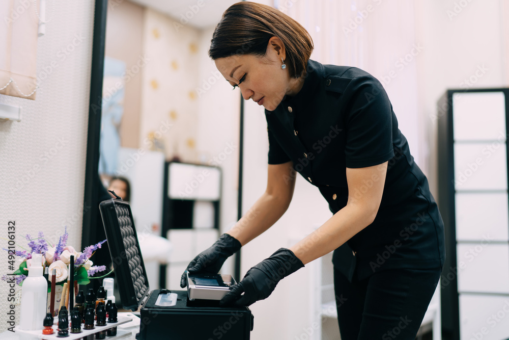Fototapeta premium Beautician taking tool for makeup or microblading