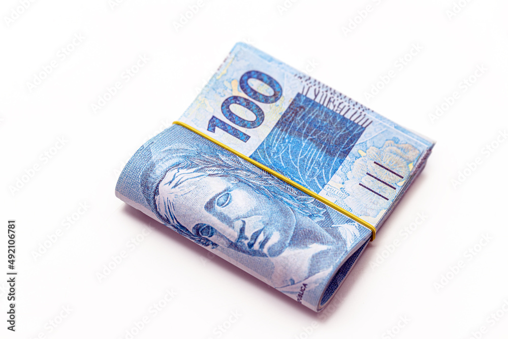 hundred reais banknotes, big wad of money from brazil on isolated white background, salary or payment hundred reais banknotes, big wad of money from brazil on isolated white background, salary or payment
