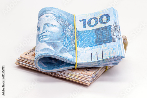 many hundred and fifty reais banknotes, brazilian money, grand prize, payment, salary, on isolated white background photo