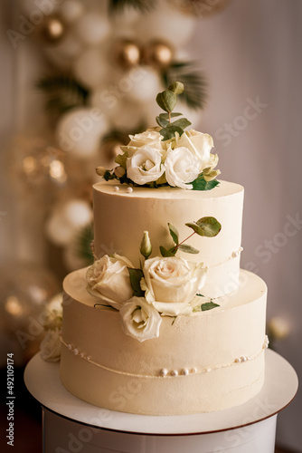 wedding cake decorated with flowers, desserts on the buffet, festive white cake