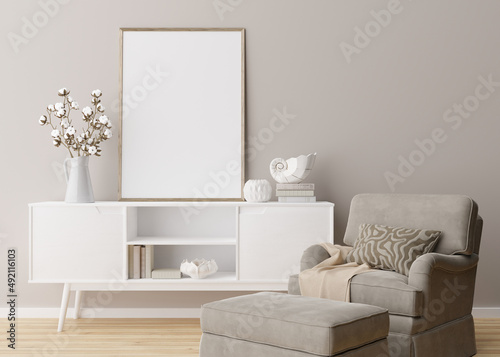 Empty vertical picture frame on cream wall in modern living room. Mock up interior in minimalist  scandinavian style. Free  copy space for picture. Console  armchair  cotton plant  vase. 3D rendering.