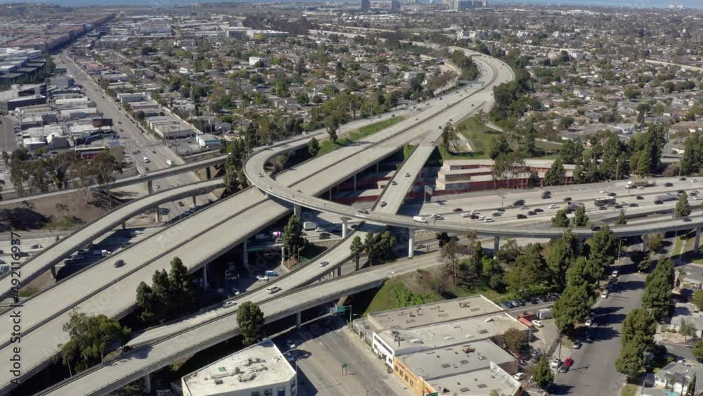 aerial top down view showing traffic on a multilevel interchange overpass and elevated road. 4K. Aerial view of road interchange or highway intersection with busy urban traffic speeding on the road. aerial top down view showing traffic on a multilevel interchange overpass and elevated road. 4K. Aerial view of road interchange or highway intersection with busy urban traffic speeding on the road.