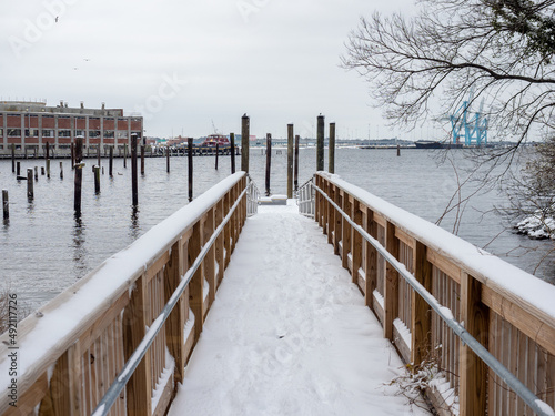 Snow covered Kayak Launch looking out to a River photo