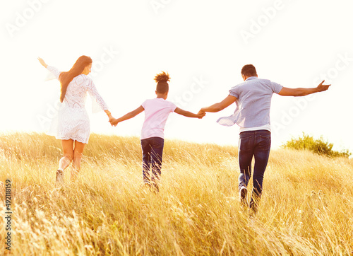 child daughter family happy mother father piggyback fun together girl cheerful field outdoor nature summer 