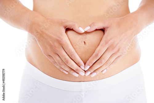 Wallpaper Mural Her child will have all of her heart. A pregnant woman forming a heart-shape with her hands over her stomach. Torontodigital.ca