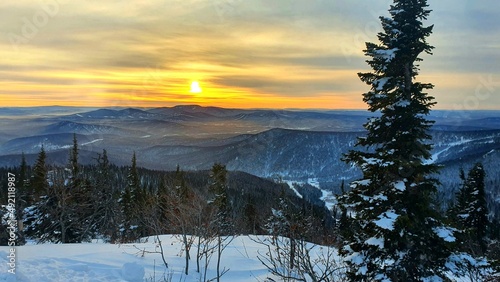 Sunrise in the mountains in winter. Majestic sunset in a winter mountain landscape. Dramatic sky.