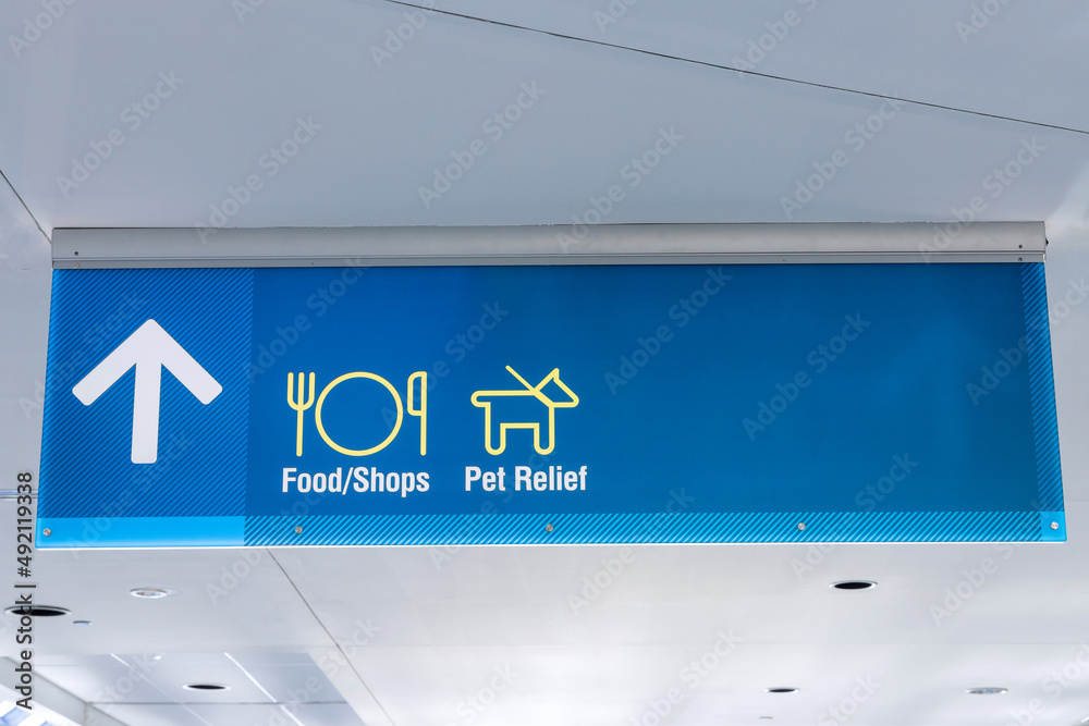 International Airport Sign Food Shops Pet Relief in interior air terminal