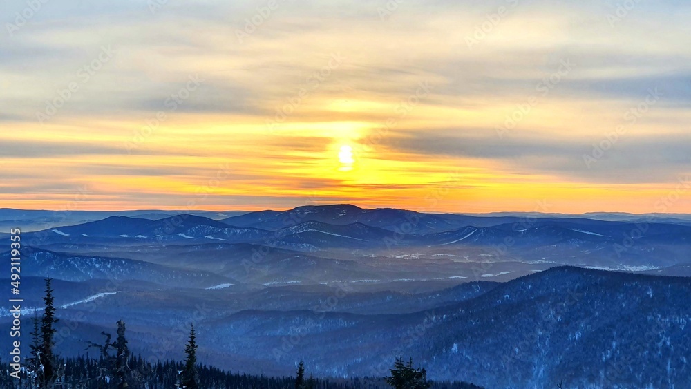 Sunrise in the mountains in winter. Majestic sunset in a winter mountain landscape. Dramatic sky. Sunrise in the mountains in winter. Majestic sunset in a winter mountain landscape. Dramatic sky.