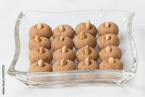 Almond cookies in a glass bowl on white background