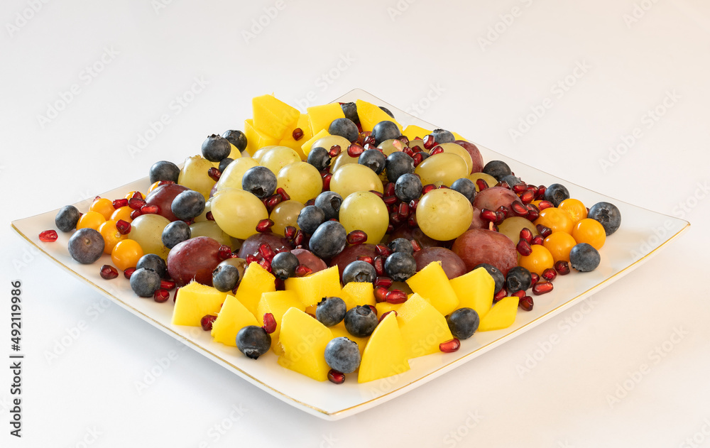 Mixed fruit salad on a plate on white background Mixed fruit salad on a plate on white background