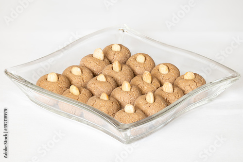 Almond cookies in a glass bowl on white background