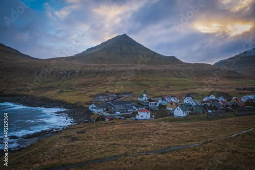 Gjogv village on the island of Eysturoy, Faroe Islands. Scandinavian colored houses. November 2021, sunset time.