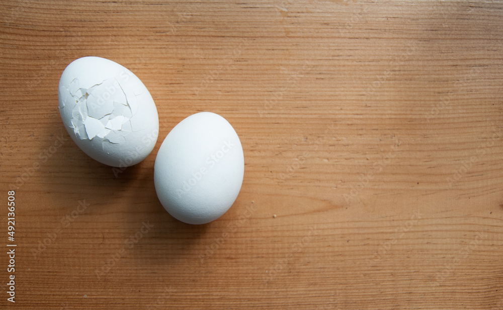 cracked eggs on wooden table