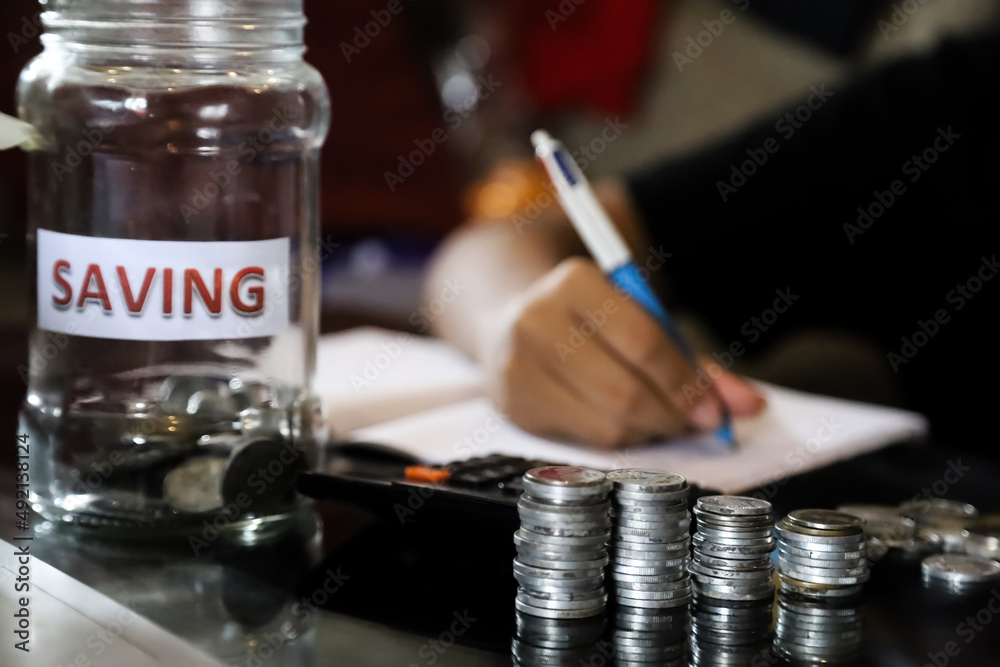 Man calculate about cost and writing make note. Man calculate about cost and writing make note.