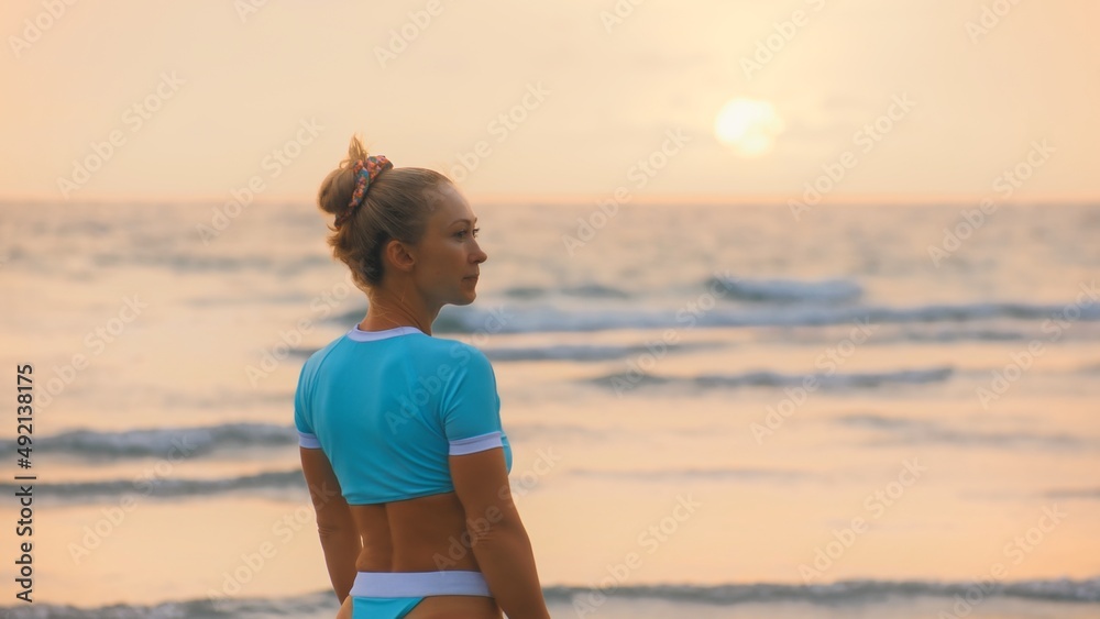SLOW MOTION GLOW MIST DARK SILHOUETTE CINEMATIC VIEW: Sexy hot woman standing on water sea. Girl stand in turquoise swimsuit. Freedom paradise holiday vacation summer beach, seaside landscape concept SLOW MOTION GLOW MIST DARK SILHOUETTE CINEMATIC VIEW: Sexy hot woman standing on water sea. Girl stand in turquoise swimsuit. Freedom paradise holiday vacation summer beach, seaside landscape concept