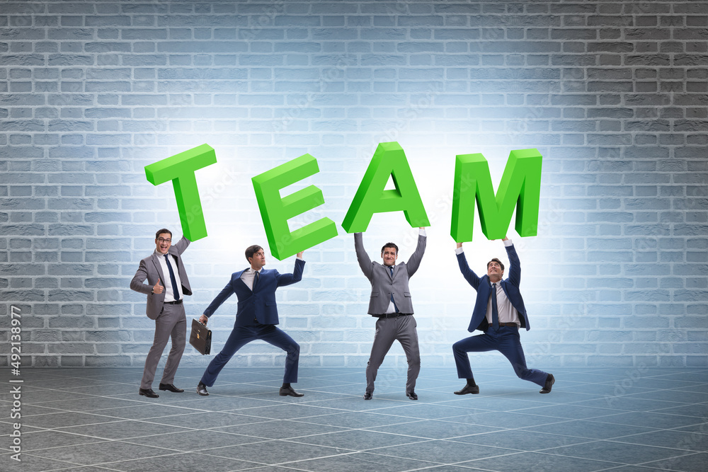 Fototapeta premium Teamwork concept with people carrying team letters
