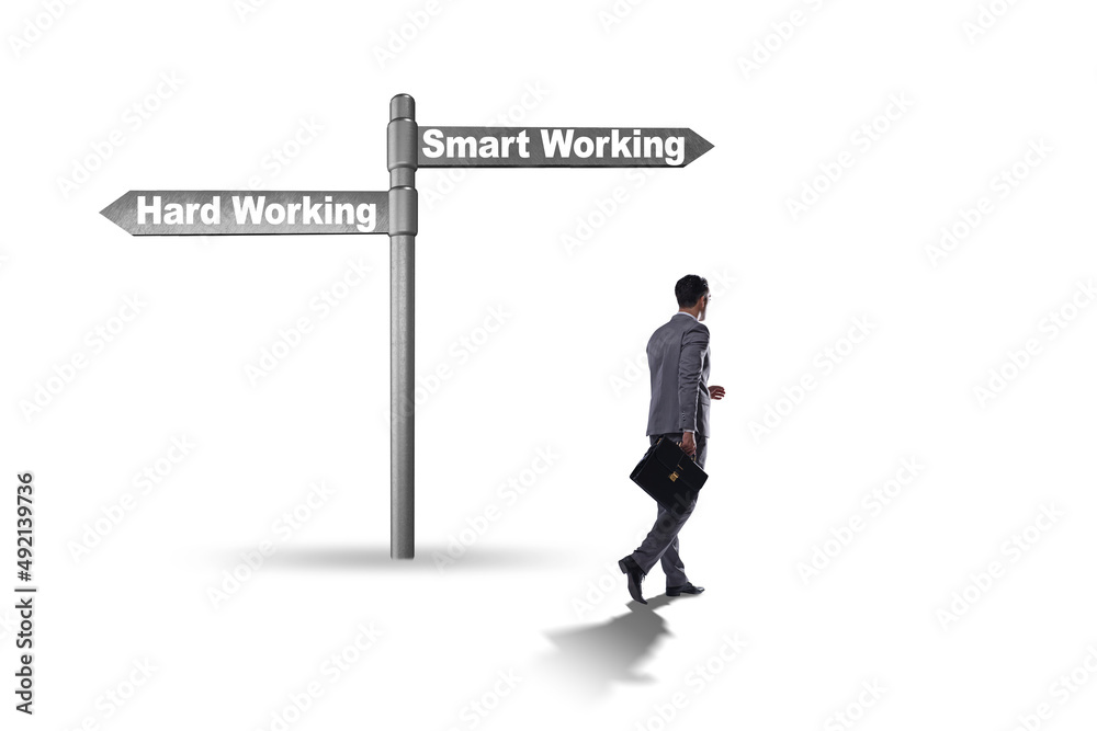 Businessman at the crossroads on working smart or hard Businessman at the crossroads on working smart or hard
