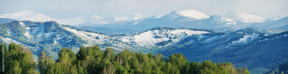 Snow in the mountains in early spring, panoramic view