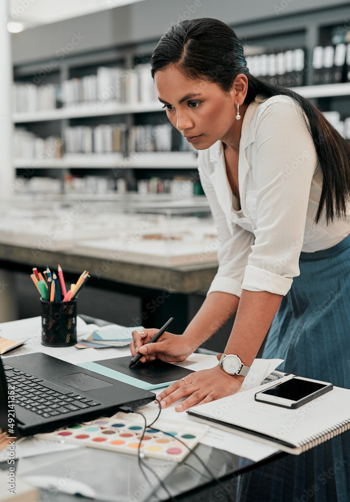 Digital technology has changed how an architect plans. Shot of a young designer working on her laptop. Digital technology has changed how an architect plans. Shot of a young designer working on her laptop.