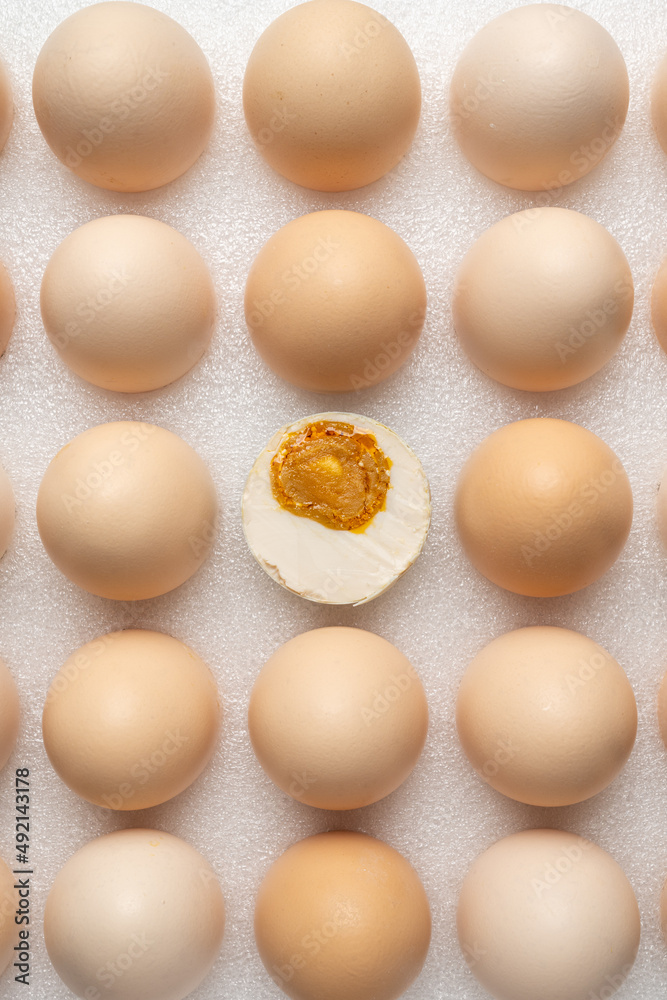 a half cut egg in the center of many eggs a half cut egg in the center of many eggs