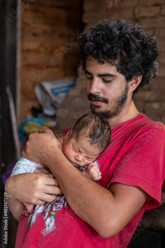 Father with his firstborn son in his arms photo