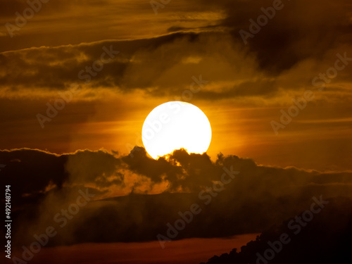 Sunrise in The Center over The Mountain at Pha Chanadai Cliff photo