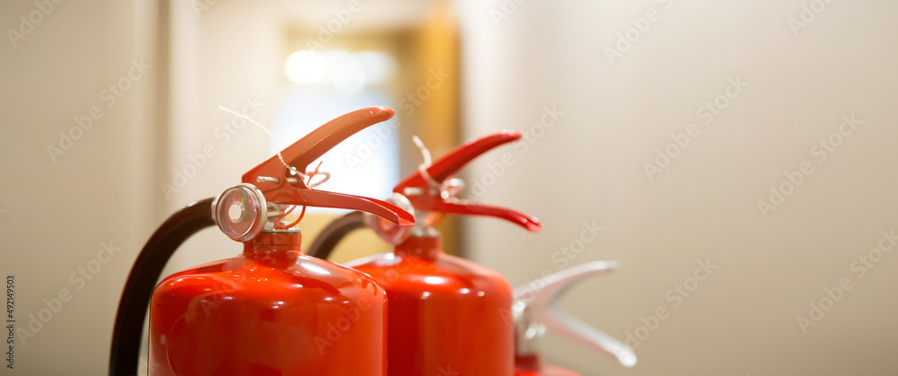 Fire extinguisher, Close-up red fire extinguishers tank in the building concepts of fire equipment for protection and prevent for emergency and safety rescue and alarm system training. Fire extinguisher, Close-up red fire extinguishers tank in the building concepts of fire equipment for protection and prevent for emergency and safety rescue and alarm system training.