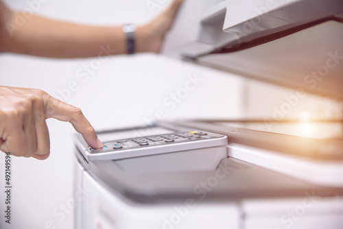 Copier printer, Close up hand office man press copy button on panel to using the copier or photocopier machine for scanning document printing a sheet paper and xerox photocopy.