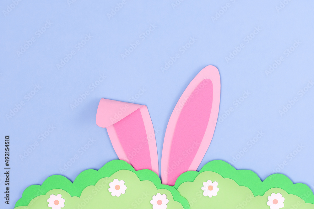 Pink Bunny rabbit ears and green grass made of paper. Happy Easter day background with bunny hide in grass. Easter greeting card template. Creative easter minimal concept with copy space. Flat lay Pink Bunny rabbit ears and green grass made of paper. Happy Easter day background with bunny hide in grass. Easter greeting card template. Creative easter minimal concept with copy space. Flat lay