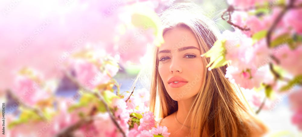 Outdoor fashion photo of beautiful young woman in flowers. Sensual girl on spring blossom background. Beauty romantic portrait of young pretty beautiful woman. Outdoor fashion photo of beautiful young woman in flowers. Sensual girl on spring blossom background. Beauty romantic portrait of young pretty beautiful woman.