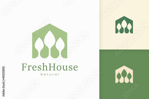 Nature green house logo with tree and leaf shape
