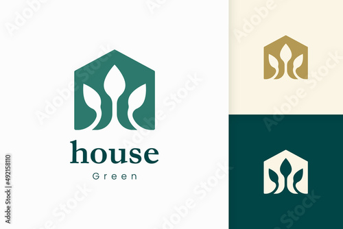 Nature green house logo with tree and leaf shape