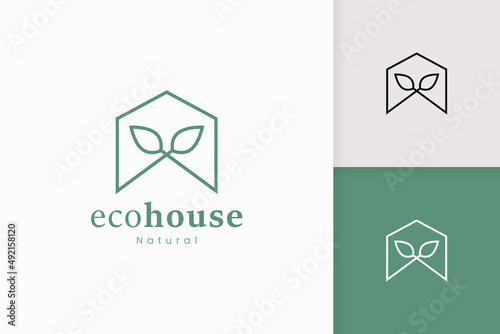 Nature green house logo with tree and leaf shape