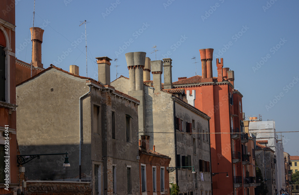 View on the old buildings with typical fireplaces. Venice, Italy.