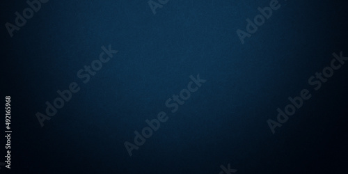 Dark blue background texture with black vignette in old vintage grunge textured border design, dark elegant teal color wall with light
