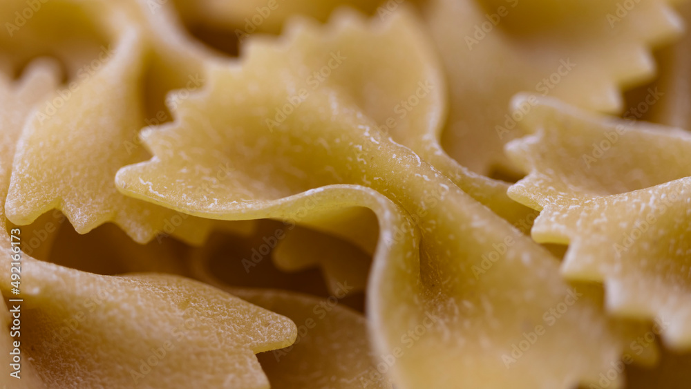 Pasta bows from durum wheat. Food background close up. Uncooked Italian pasta. Pasta bows from durum wheat. Food background close up. Uncooked Italian pasta.