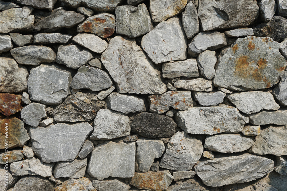 The limestone wall is constructed by a gray wall for background or texture. The limestone wall is constructed by a gray wall for background or texture.