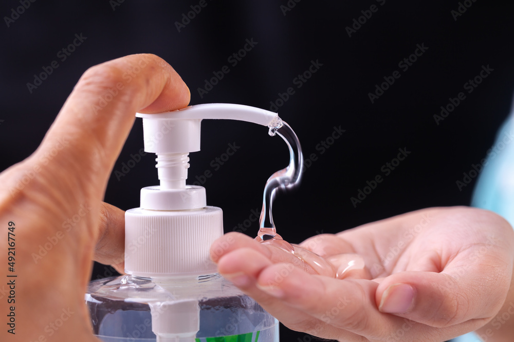 hand holding and press a bottle of alcohol gel hand holding and press a bottle of alcohol gel