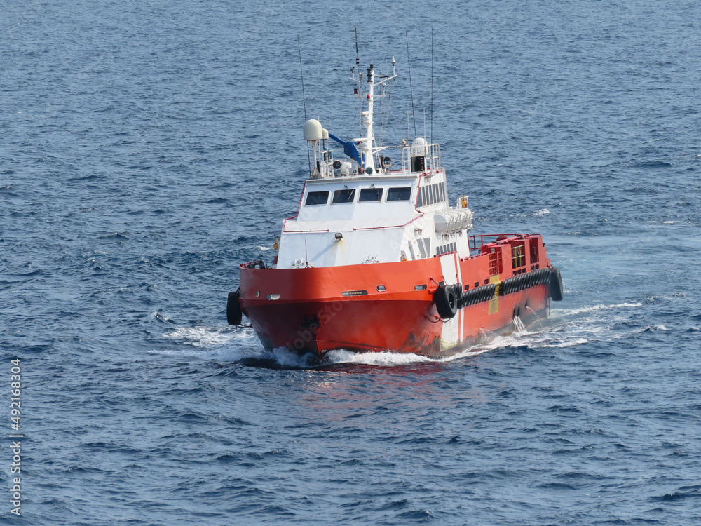 Supply boat transfer the cargo for supporting oil and gas industry and moving cargo from the boat to the platform. Boat is waiting transfer cargo and crews to platform.